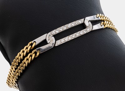 18 kt Gold Brillant-Armband, GG/WG 750/000,2-rhg. GG-Kettenglieder, länglich ovales WG- Mittelteil, 17 Brillanten zus. ca. 0.34 ct Weiß/si, L. ca. ...