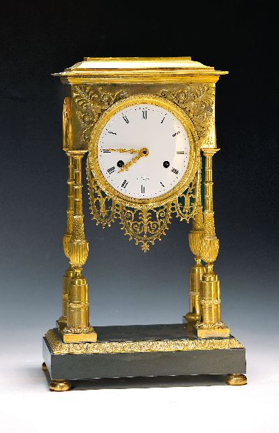 Portaluhr, Frankreich, Mitte 19. Jh., Messinggehäuse verziert, Sockel brüniert, Uhr getragen von 4 filigranen Säulen, in den Ecken Palmetten, mit ...