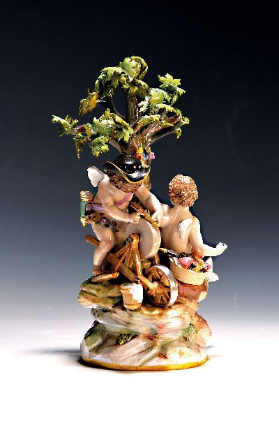 Porzellanfigur, Meissen, um 1880/90, Modellnr. E 26, Amorettengruppe unter einem Baum, ihre Pfeile schleifend, Fackel fehlt, polychrom bemalt, ...
