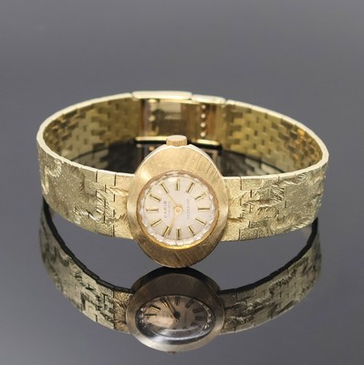 CARIB Damenarmbanduhr in GG 585/000, Schweiz um 1965, Handaufzug, Goldband, Boden aufgedr., silb. Zifferbl. m. aufges. Std.- Ind., gold. Zeiger, Kal. ...