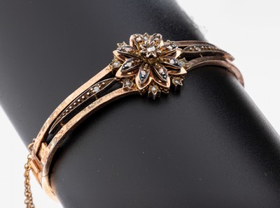 18 kt Gold Diamant-Armreif, um 1880-90, RG 750/000 gepr., blütenf. Kopf mit Diamantrosen zus. ca. 0.10 ct, ca. 5.7 x 5 cm, Klappscharnier, ...