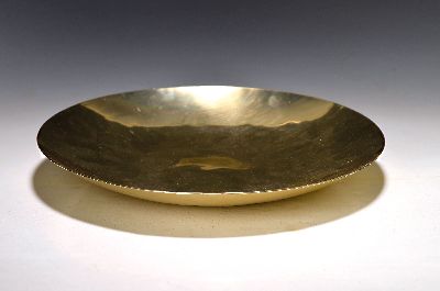 Anbietschale aus dem Zeppelin, um 1930, Aluminium vergoldet, Treibarbeit, mit Bodenmarke Zeppelin, H. ca. 4cm, D. ca. 32cm, Entwurf wohl Fritz August ...
