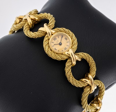 18 kt Gold Damenschmuckuhr, GG 750/000, 8 kreisförmige Elemente, gekordelt, goldfarb. Zifferblatt, kreuzförmige Zwischenelemente, L.ca. 17 cm, ca. ...
