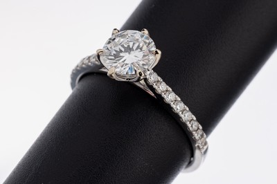 18 kt Gold Brillant-Ring, WG 750/000, mittig Brillant ca. 1.0 ct hochfeines Weiß(E)/vvs1, Ringschultern mit Brillanten zus. ca. 0.27 ct ...