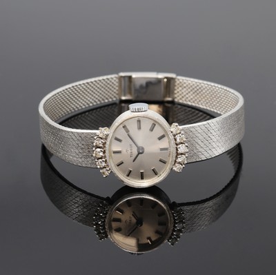 TISSOT Damenarmbanduhr in WG 585/000 mit Diamanten, Schweiz um 1965, Handaufzug, Boden aufgedr., Geh. am Milanaiseband m. 10 Diamanten bes., silb. ...