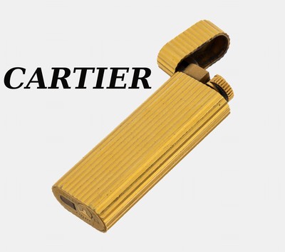 CARTIER Feuerzeug, Metall verg., gerillt, sign und num., Fkt. ungeprüft, L. ca. 7 cm, Gebr.-Spuren