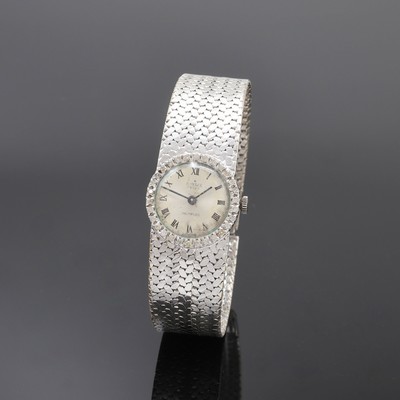 EVELIX Damenarmbanduhr in WG 750/000 mit Diamantlünette, Handaufzug, Schweiz 1960er Jahre, Boden aufgedr., silb. Zifferbl. altersbed. fl./pat., ...