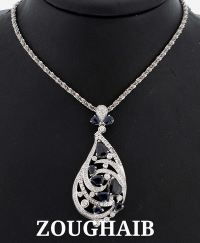 18 kt Gold Saphir-Brillant-Anhänger, WG 750/000, bewegl. gearbeitet, 9 facett. Saphirtropfen zus. ca. 6.40 ct, Brillanten zus. ca. 1.67 ct feines ...