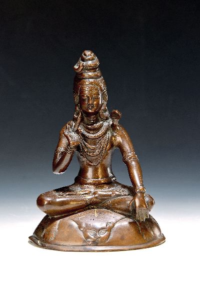 Bronzefigur/Shiva, Indien, wohl 19. Jh., patiniert, mit Schlange um den Hals, auf einem Löwenfell sitzend, H. ca. 21 cm