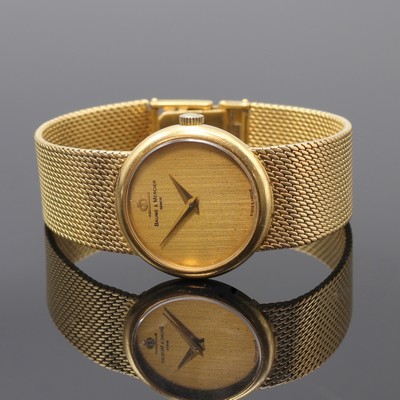 BAUME & MERCIER Damenarmbanduhr in GG 750/000, Schweiz um 1970, Handaufzug, orig. Goldband, Boden aufgedr., champagnerfarb. Zifferbl. pat./fl., gold. ...