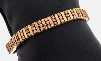 14 kt Gold Armband, RG 585/000, im Wechsel Glieder mit geschwungenem Element und Glieder mit kl. Blüten, B. ca. 0.9 cm, L. ca. 19.5 ...
