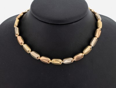 14 kt Gold Collier, GG/WG/RG 585/000, bohnenf. Glieder durch Kugelelemente verbunden, L. ca. 44 cm, Kastenschloss mit Sicherheitsacht, ca. 28 g