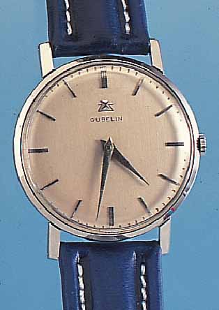 GÜBELIN HERRENARMBANDUHR, REF.-NR. 162768, SCHWEIZ UM 1964, EDELST., BODEN U. GLASRAND GEDR., VERS. BLATT, BAND NEU, 18 ST., HAND- AUFZUG, ...