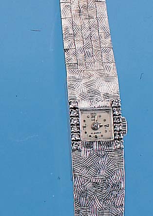 ONSA DAMENSCHMUCKUHR, REF.-NR. 13245, SCHWEIZ UM 1964, WG 750/000, RHOD., LüNETTE SEITL. M. 12 8/8 DIAMANTEN BES., BODEN GEDR., ...