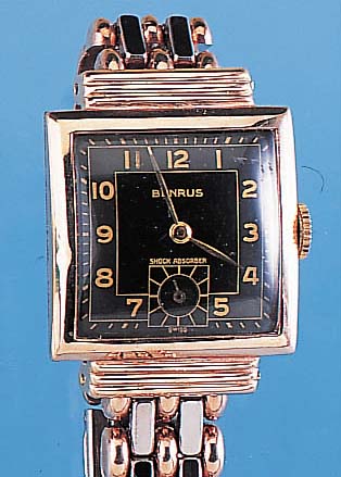BENRUS HERRENARMBANDUHR, REF.-NR. 313726, SCHWEIZ UM 1950, METALL ROTVERG., EDELST.-BO- DEN GEDR., ZEITIDENT. METALLBAND M. EDELST.- FALTSCHL., ...