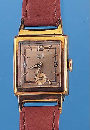 GUB Herrenarmbanduhr, Metallgeh. hartverg., altersbed. ber., Edelst.-Bod. aufgedr., außer Krone, Glas u. Lederbd. Orig.-Zustand um 1955,2 farb. ...