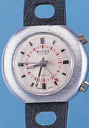 ZUREX ARMBANDWECKER, SCHWEIZ UM 1970, MAS- SIV MESSING VERCHR., EDELST.-BODEN GESCHR., 17 ST., SCHWEIZER STIFTENANKERW., GEH.-U. WECK-WERK ...