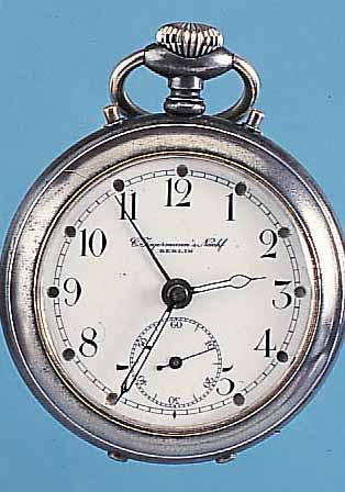 JUNGHANS TASCHENWECKER, DEUTSCHLAND UM 1920,STAHL AUFSTELLB., EMAILBL. M. VERKäUFERSIGN. (C. JäGERMANNS NACHFOLGER, BERLIN), BLATT FEINHAARR., ...