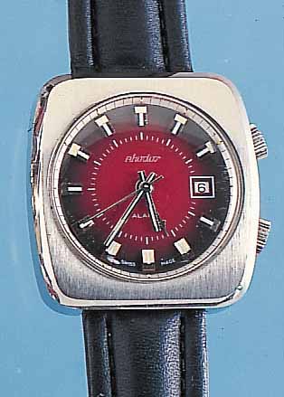 RHODOS ARMBANDWECKER, REF.-NR. 1178, SCHWEIZUM 1972, EDELST. MASSIV, BODEN GESCHR., 17 ST.HANDAUFZUG, GEH.-U. WECKWERK GETR. FEDERH., SINNGEM. ...
