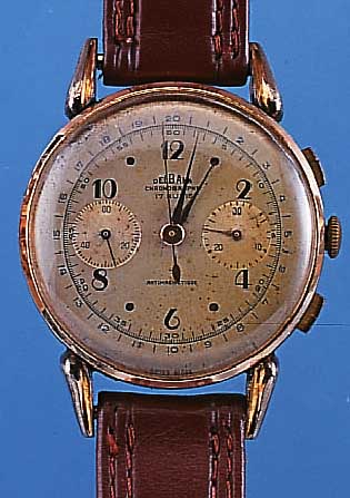 DELBANA ARMBANDCHRONOGRAPH, SCHWEIZ UM 1947,METALL M. RG-AUFL. BER., BODEN U. GLASR. GEDR., ORIG.-BLATT FARBL. GET., 30-MIN.-STOPP-ZäHLER, 17 ...
