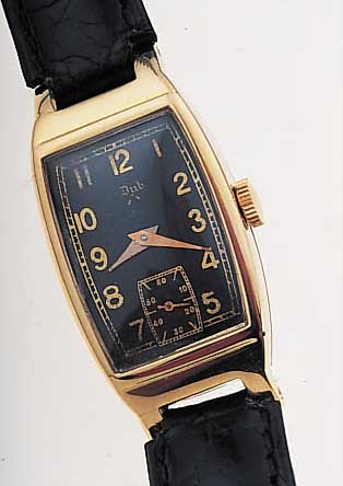 DUB DAMENARMBANDUHR, SCHWEIZ/FRANKREICH UM 1938, GG 750/000, TONNENFORM, BODEN GEDR., INNENSCHALE GEGEN MAGNETISMUS, FORMANKERW. VONFEF, 15 ST., ...