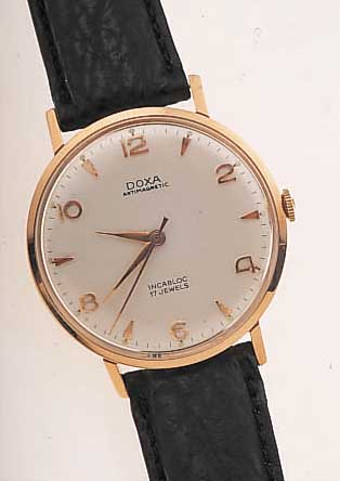 DOXA HERRENARMBANDUHR ANTIMAGNETIK, SCHWEIZ UM 1965, RG 585/000, GLASR. GEDR., D. CA. 34 MM, LEDERB. NEU, BLATT PERF. REST., RUNDANKER-W., BAUWEISE ...