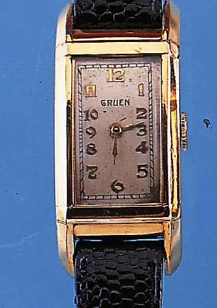 GRUEN HERRENARMBANDUHR, SCHWEIZ/USA UM 1938,METALL M. GG-AUFLAGE, EDELST.-BODEN GEDR., IN SICH GEW., RECT.-FORM, LEDERB. NEU, OHNE SEK., ...
