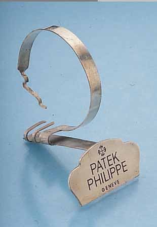 PATEK PHILIPPE DEKORATIONSUHRENSTäNDER, UM 1955, METALL VERS., ALTERSBED. FARBL. GET.,BESTELL-NR. 524