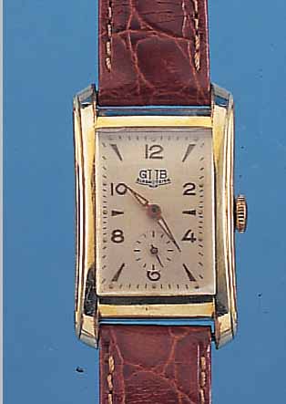 GUB HERRENARMBANDUHR GüTEKLASSE I, DEUTSCH- LAND UM 1955, METALL GELBVERG., SELTENE GEH.- FORM, TAILL. ANGED., EDELST.-BODEN GEDR., IN SICH L. ...