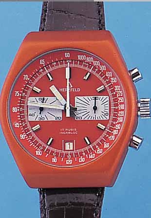 HERZFELD ARMBANDCHRONOGRAPH, SCHWEIZ UM 1974METALLGEH. ORANGE MATT., EDELST.-BODEN GE- SCHR., BEI FERTIGST. WASSERGESCH., MINERAL- FLACHGL., ...