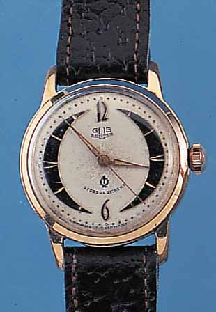 GUB HERRENARMBANDUHR GüTEKLASSE, REF.-NR. 244129, DEUTSCHLAND UM 1958, METALL M. GG- AUFLAGE, EDELST.-BODEN GESCHR., BEI FERTIGST. ...