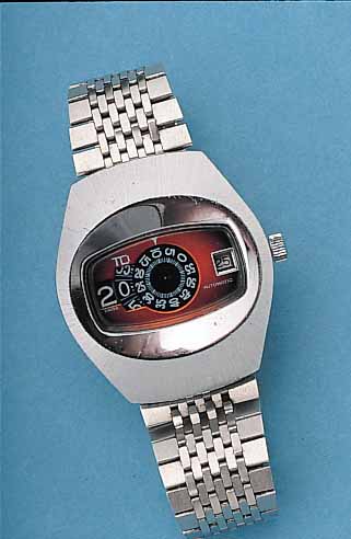 TD HERRENARMBANDUHR DIGITAL, SCHWEIZ UM 1970METALL MASSIV-GEH. HARTVERCHR., EDELST.-SCHR.-BODEN, NEUTR. EDELST.-BAND, AUTOMATIK, DATUM U. STD. ...