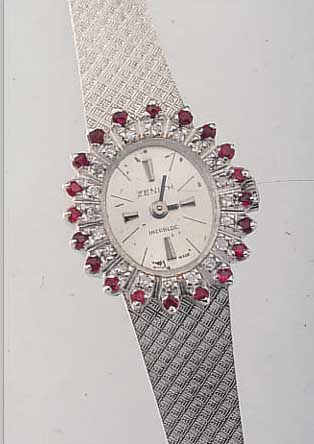 ZENITH DAMENSCHMUCKBANDUHR, SCHWEIZ UM 1970,NEUTR. WG 750/000-GEH. INCL. WG-BAND, LÜNETTE 2-REIHIG M. 20 8/8 DIAMANTEN ZUS. CA. 0,4 CT, 20 RUBINE ...
