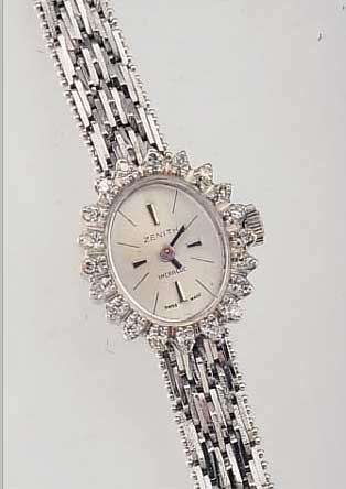 ZENITH DAMENSCHMUCKBANDUHR, SCHWEIZ UM 1972WG 750/000 INCL. BAND RHOD., OVALLüNETTE M. 20 8/8 DIAMANTEN ZUS. CA. 0,4 CT L. GET. ...