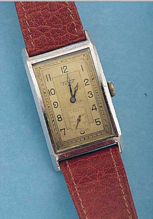 TISSOT HERRENARMBANDUHR, REF.-NR. 876189, SCHWEIZ UM 1936, METALL VERCHR., EDELST.- BODEN GEDR., GR. RECT.-FORM, MAßE CA. 43 X 25 MM, 2-FARB. ...
