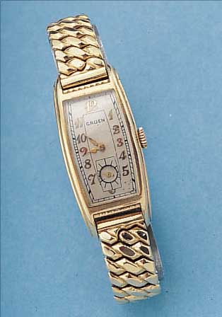 GRUEN ARMBANDUHR, SCHWEIZ/USA UM 1938, METALL VERG., GEZOGENE TONNENF. IN SICH GEW., EDELST.-BODEN GEDR., BOMB. MINERALGL., VERG. ...