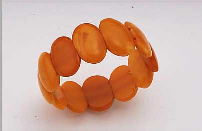 ARMBAND MIT BERNSTEINEN, LABEL: SBM, KöNIGSBERG CA. 30ER JAHRE, OVALE OPAKE OCKER- FARB. BERNSTEINE, GUMMIZUG, D. CA. 6 CM, VGL. LIT.
