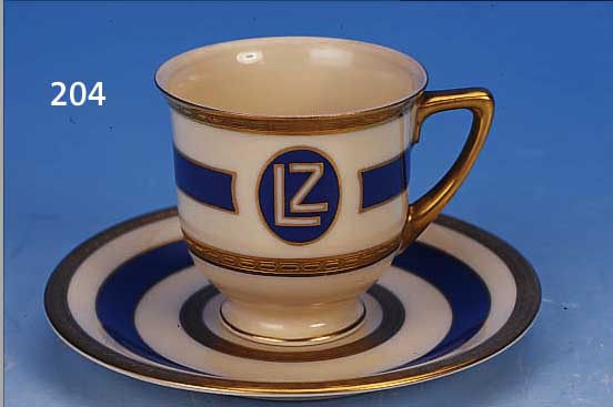 MOKKATASSE MIT UNTERTASSE, HEINRICH & CO. SELB, 1928, BORDGESCHIRR DES LUFTSCHIFFES LZ GRAF ZEPPELIN, SOG. KNOCHENPORZELLAN, EL- ...