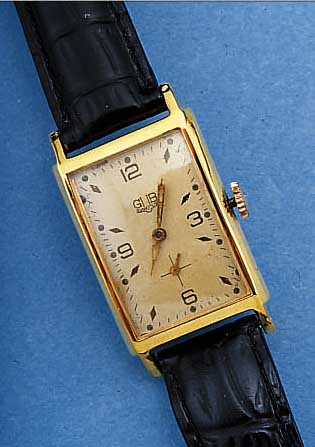 GUB HERRENARMBANDUHR, DEUTSCHLAND UM 1955, METALL HARTVERG., EDELST.-BODEN GEDR., BLATT PROV. BEFEST., FORMANKERW., HANDAUFZUGKAL. 662,2, ...