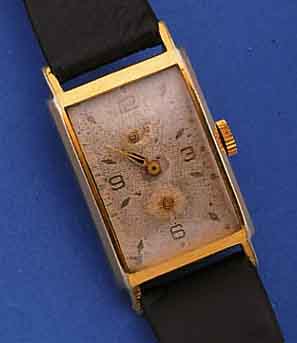 GUB HERRENARMBANDUHR, DEUTSCHLAND UM 1955, REF.-NR. 20210, METALL VERG., EDELST.-BODEN GEDR., IN SICH L. GEW., BLATT FL., FORMANKERW.KAL. 662,2 ...
