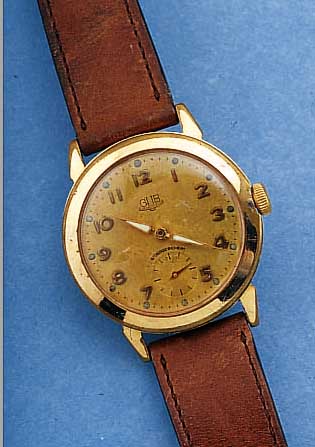 GUB HERRENARMBANDUHR, REF.-NR. 61337, DEUTSCHLAND UM 1954, METALL HARTVERG., BER., ORIG.-BLATT, FARBL. GET., 15 ST., HANDAUFZUG- KAL. 60, ...