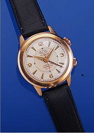 NILAX ARMBANDWECKER, SCHWEIZ UM 1960, METALLVERG., EDELST.-BODEN GESCHR., GUILL. U. VERS. BLATT, AUßER LEDERB. ORIG.-ZUSTAND, 17 ST., ...