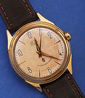 GUB HERRENARMBANDUHR, REF.-NR. 252974, DEUTSCHLAND UM 1958, METALL HARTVERG., BER., EDELST.-BODEN GESCHR., ORIG.-BLATT ALTERSBED. FARBL. GET., ...