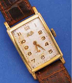 GUB HERRENARMBANDUHR, REF.-NR. 96300, DEUTSCHLAND UM 1953, METALL RECT., BER., EDELST.-BODEN GEDR., BLATT VERS., FL., FORM- ANKERW., ...