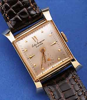JULES JÜRGENSEN HERRENARMBANDUHR, SCHWEIZ/ USA UM 1952, GG 585/000, AUFWEND. RECT.-FORM, M. GESP. BANDANST., KONKAVGL., BODEN GEDR., BLATT ...