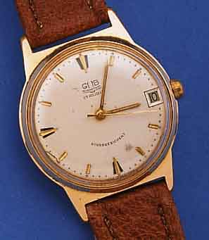 GUB ARMBANDUHR, REF.-NR. 026810, DEUTSCHLANDUM 1965, METALL ROTVERG., BER., EDELST.-BODEN GEDR., ORIG.-BLATT FL., DATUM, 17 ST., HAND- AUFZUGKAL. ...
