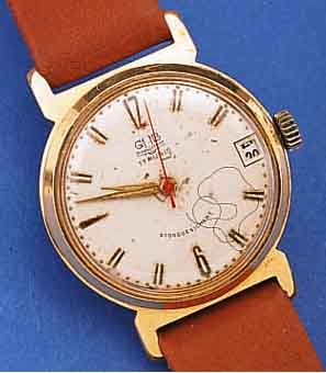 GUB HERRENARMBANDUHR, REF.-NR. 019368, DEUTSCHLAND UM 1963, METALL VERG., BER., EDELST.-BODEN GEDR., ZENTRALSEK., DATUM, ORIG.-BLATT ...