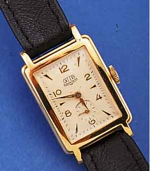 GUB HERRENARMBANDUHR, DEUTSCHLAND UM 1956, METALL HARTVERG., EDELST.-BODEN GEDR., ORIG.- BLATT ALTERSBED. L. FL., FORMANKERW. M. IND. KL. SEK., 15 ...