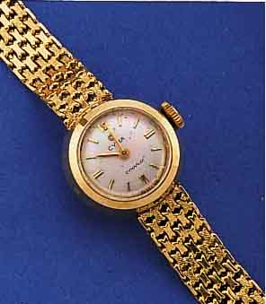 CYMA/TAVANNES DAMENGOLDBANDUHR, SCHWEIZ UM 1955, GG 750/000 INCL. GG-BAND, NEUTR. HüLLE, BODEN GEDR., VERS. BLATT M. AUFGEL. GOLD-STD.-ZEICHEN, ...