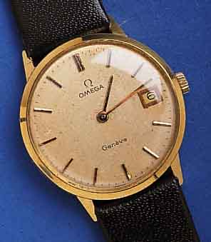 OMEGA HOMEGA HERRENARMBANDUHR GENEVE, SCHWEIZ UM 1975, GG 750/000, BODEN U. GLASR. GEDR., VERS. BLATT, L.FL., WERK VERG., HANDAUFZUG- KAL. 1030, ...